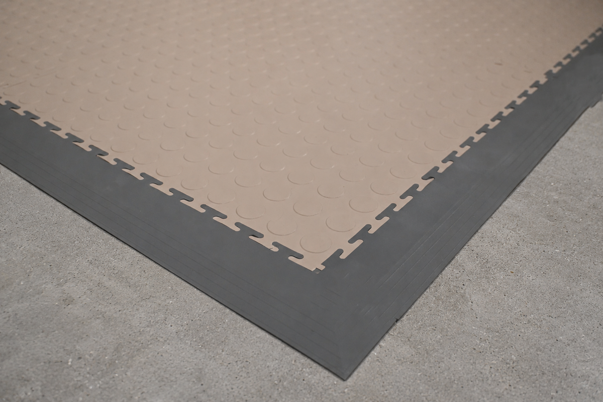 Smooth edge ramps and corner transition pieces for interlocking garage tile flooring